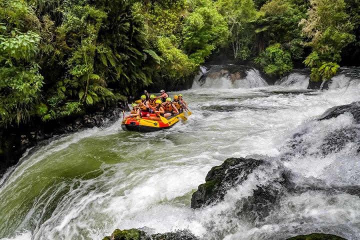 a man riding a wave on top of a river