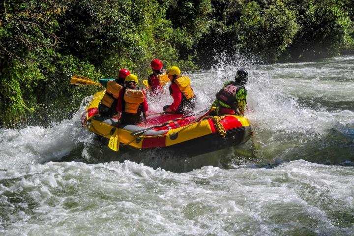 a man riding on a raft in a body of water