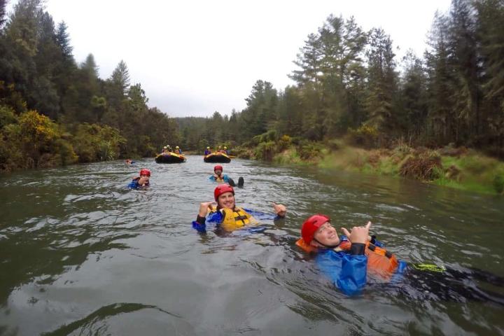 a group of people riding on a raft in a body of water