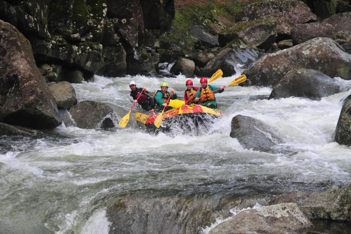 a group of people on a raft in a pool of water